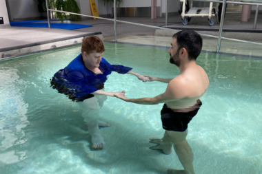 Woman and man doing hydrotherapy in a pool.