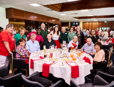Clients and staff posing in a group photo.