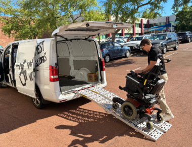 Man loading mobility scooter into the back of van via a ramp
