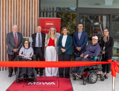 Attendees pose in front of a ribbon at the opening of MSWA Shenton Park.