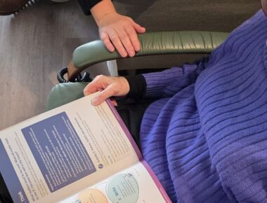 Book opened on a someone's lap.