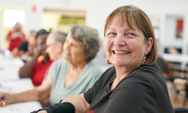woman smiling at the camera in a social setting