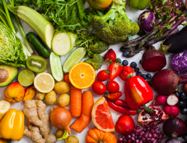 fruits and vegetables on a table grouped by colour