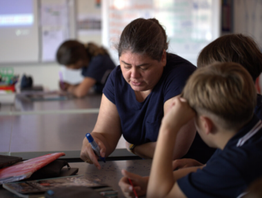 Woman in school setting with children
