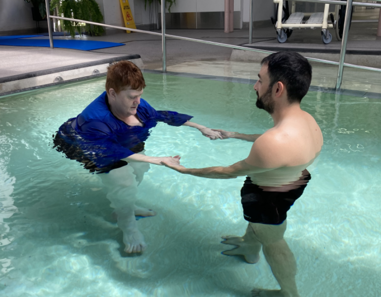 Woman and man doing hydrotherapy in a pool.