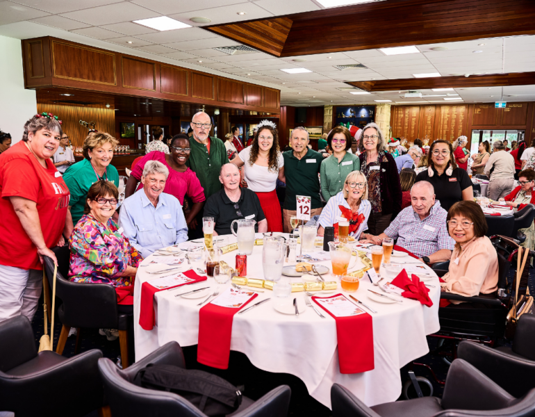 Clients and staff posing in a group photo.