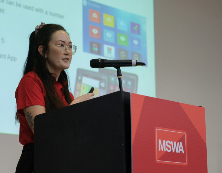MSWA staff member speaking at the lectern.