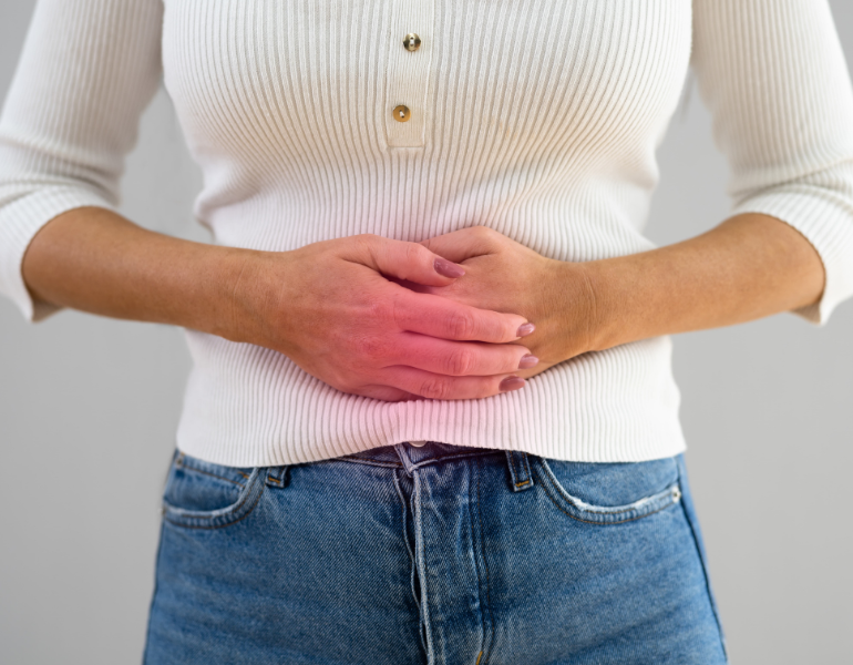 Woman resting her hands on her stomach