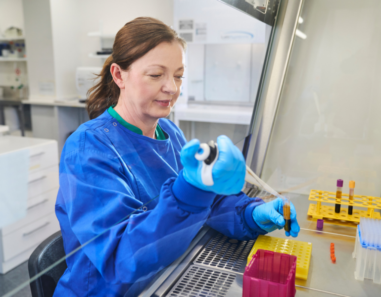 Perron Institute researcher in lab using a pipette.