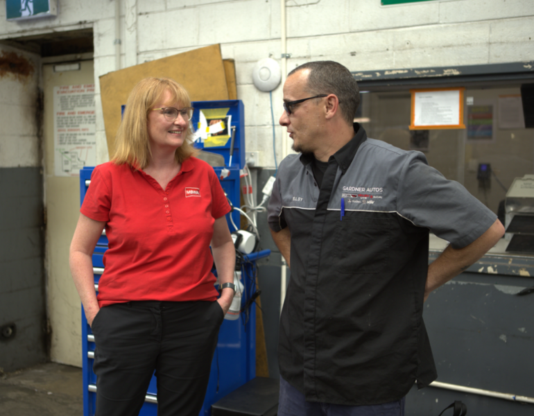 mswa and client speaking in a mechanic workshop