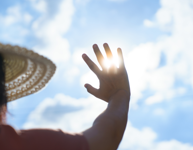 woman wearing a hat under the sun