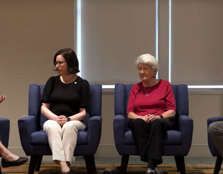 Four people having a panel discussion.
