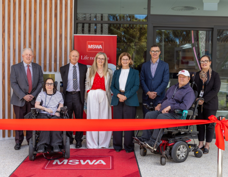 Attendees pose in front of a ribbon at the opening of MSWA Shenton Park.