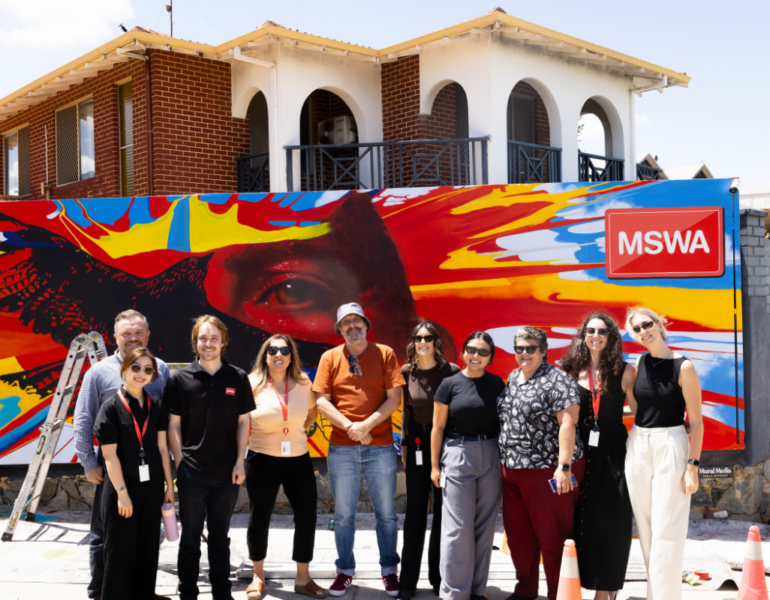 MSWA Marketing team and Client, Hank posing in front of his mural, I Found a Feather.