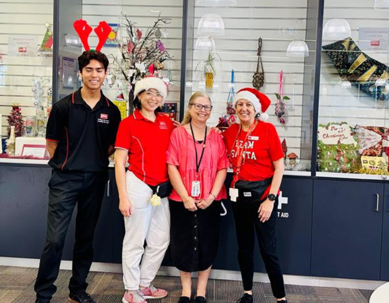 People in Christmas outfits posing in Bunbury service centre