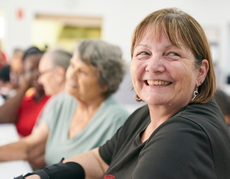 woman smiling at the camera in a social setting