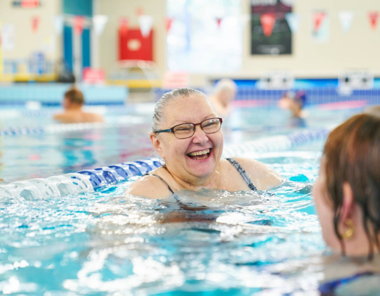 Woman smiling in pool.