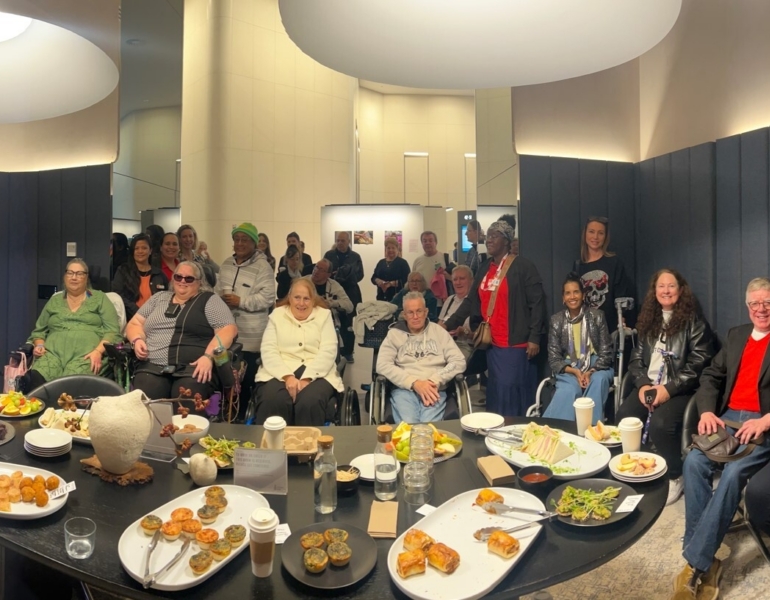 clients posing in a group photo at morning tea