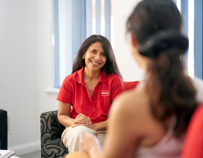 client and counsellor sitting on armchairs during a session