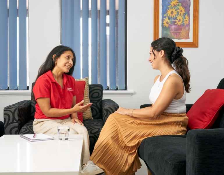 client and counsellor sitting on armchairs during a session