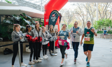three people crossing the start line at MSWA Step Up