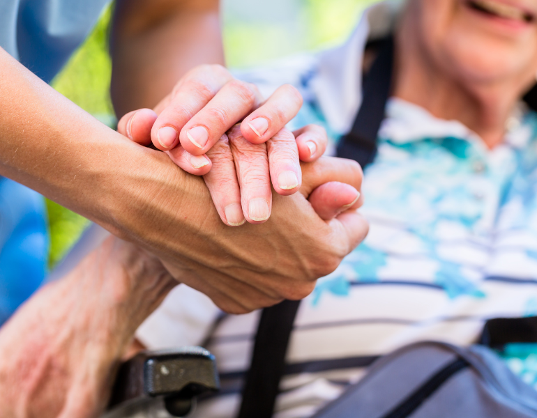 two people holding hands in support