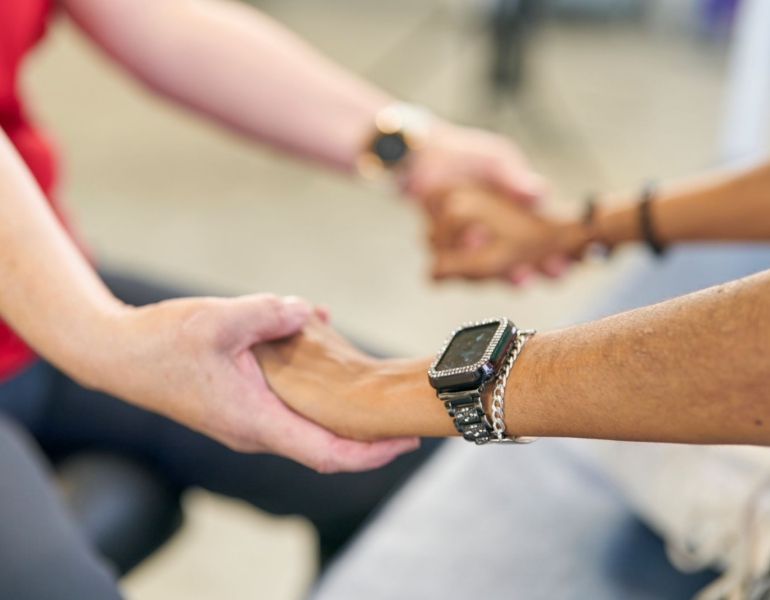 Two people holding hands