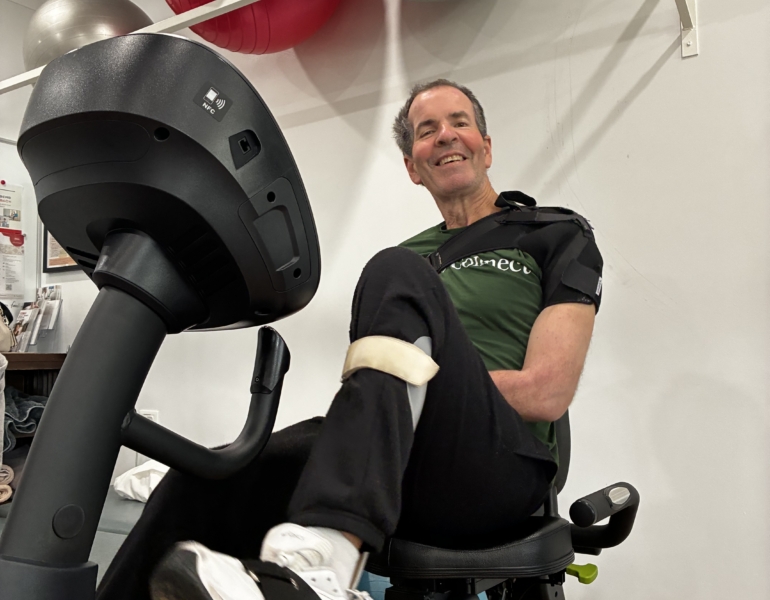 miles sitting on an exercise bike