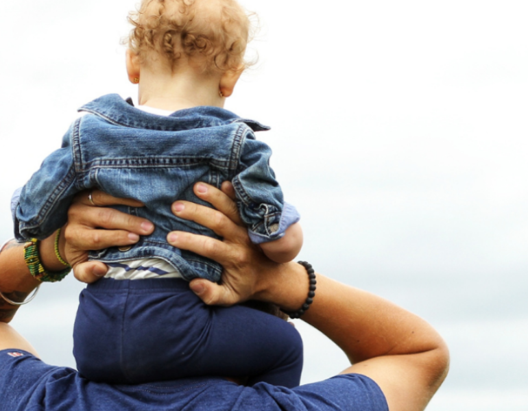 child on mans shoulder