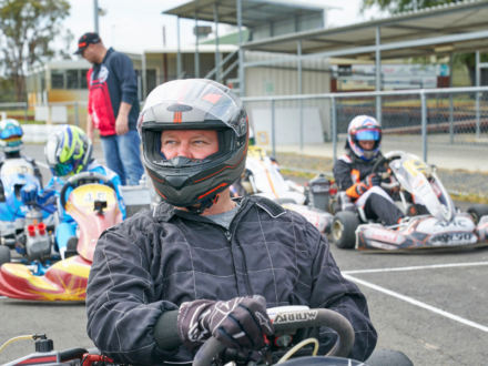 man wearing a helmet in a go kart