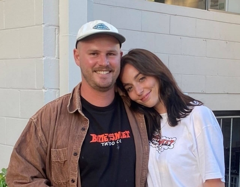 two people smiling at the camera
