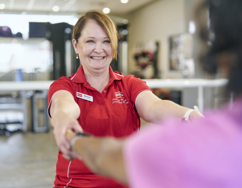 MSWA employee holding hands with client in a service centre