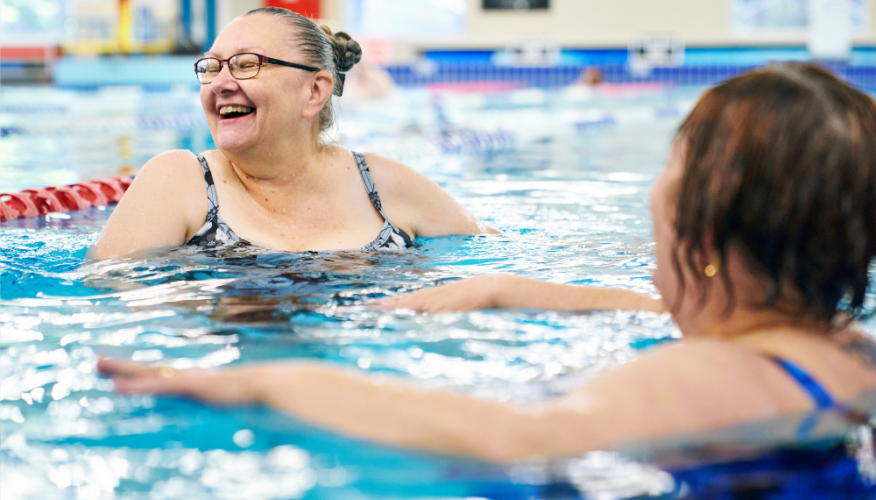 woman smiling and swimming in pool
