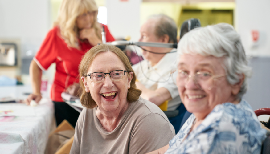 two women smiling and looking at the camera