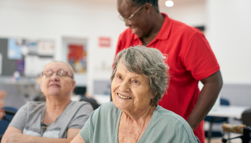 woman smiling at the camera in a social, community setting