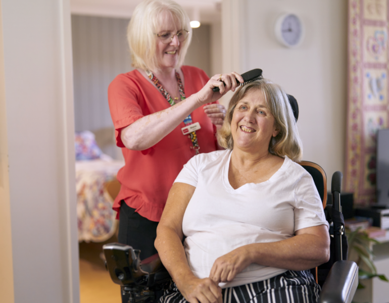 MSWA staff brushing client's hair
