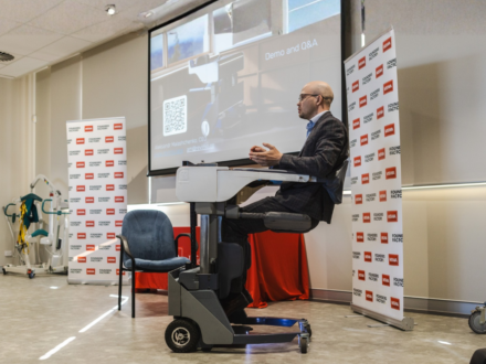 Man sitting in a robotic machine.
