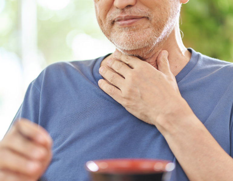 man with a hand on his throat