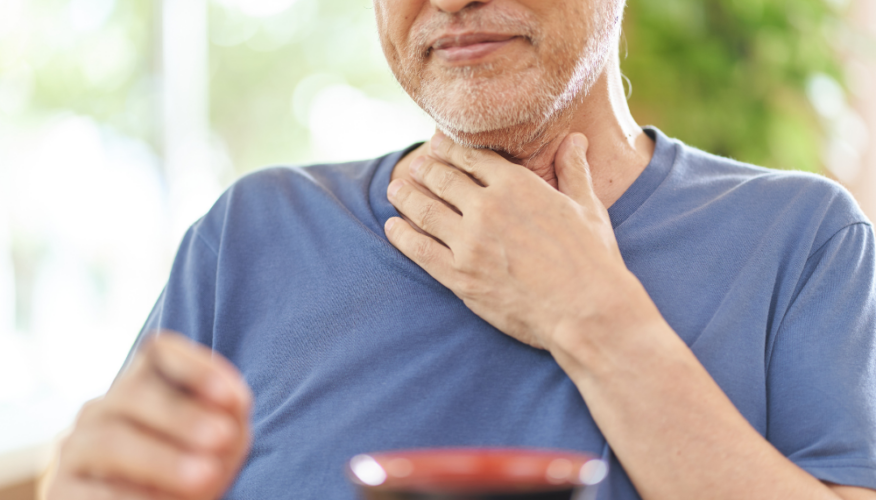man with a hand on his throat