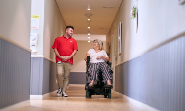 MSWA staff and client walking down a corridor at a service centre