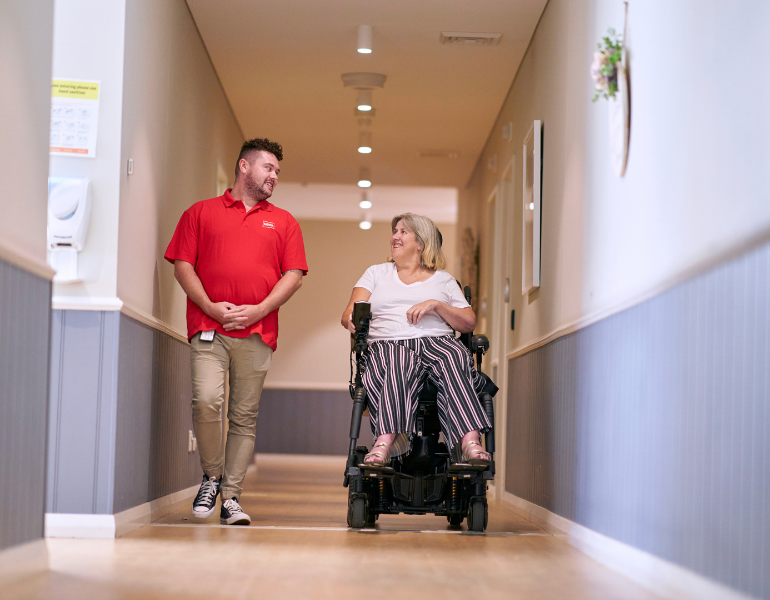 MSWA staff and client walking down a corridor at a service centre