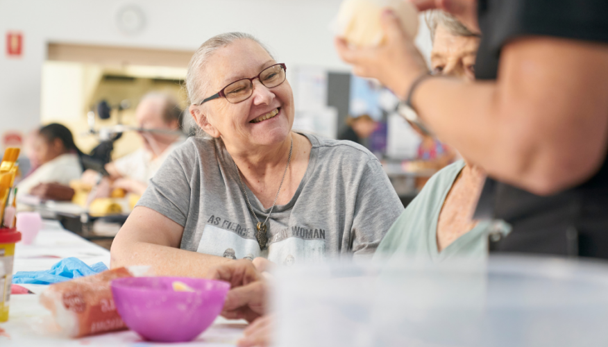 woman smiling during an arts and crafts session
