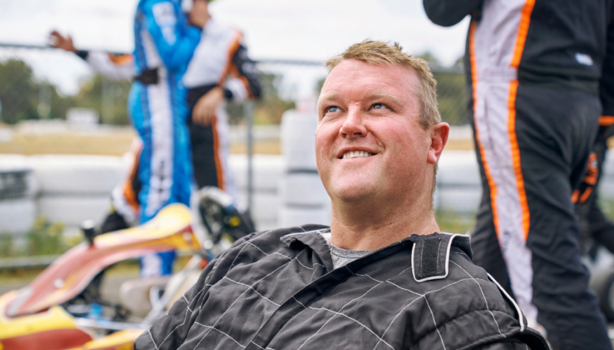 man smiling in a go kart car