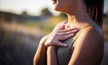 woman holding her arms on her chest