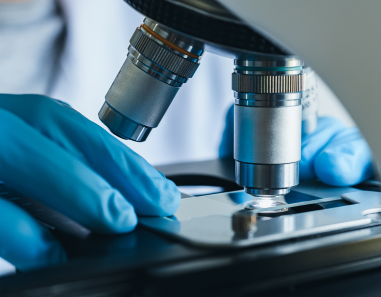 researcher using a microscope